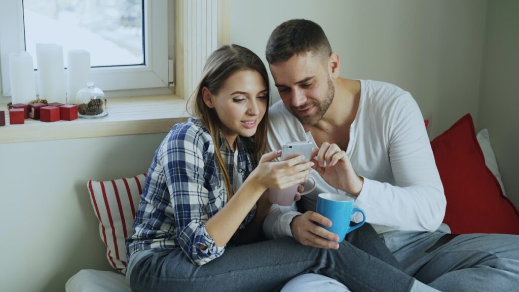 Couple comparing best budget apps for couples together on a smartphone