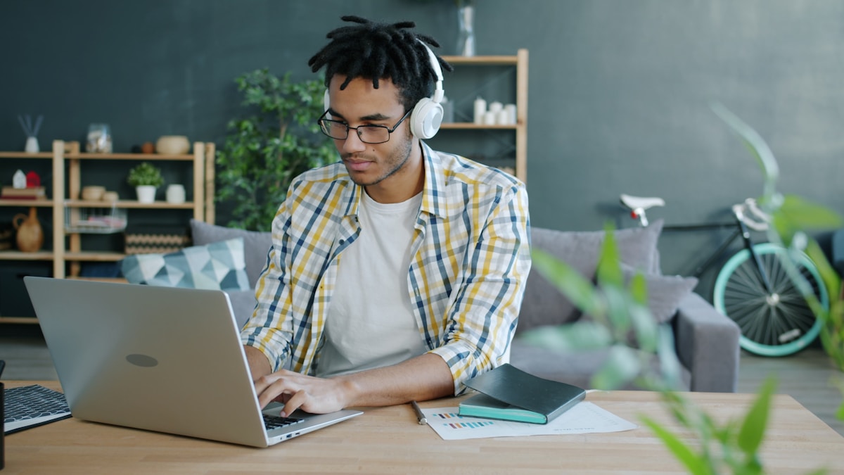 Freelancer working from home managing irregular income on a laptop