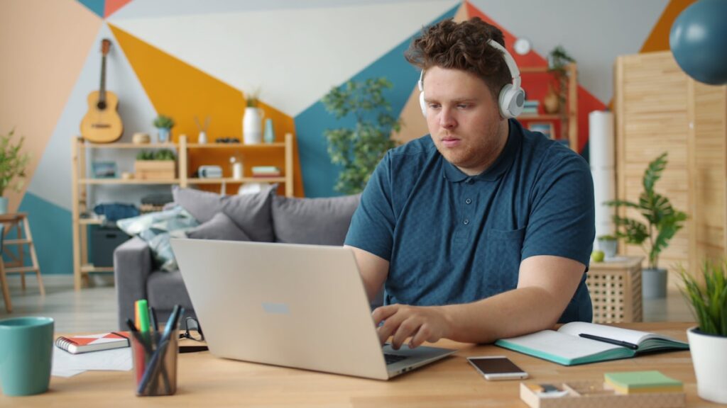 Freelancer working from home tracking irregular income on a laptop