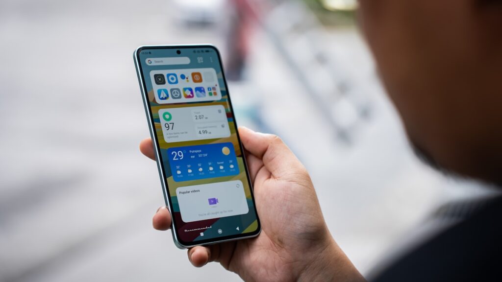 Person using iSave budget and expense tracker app on a smartphone