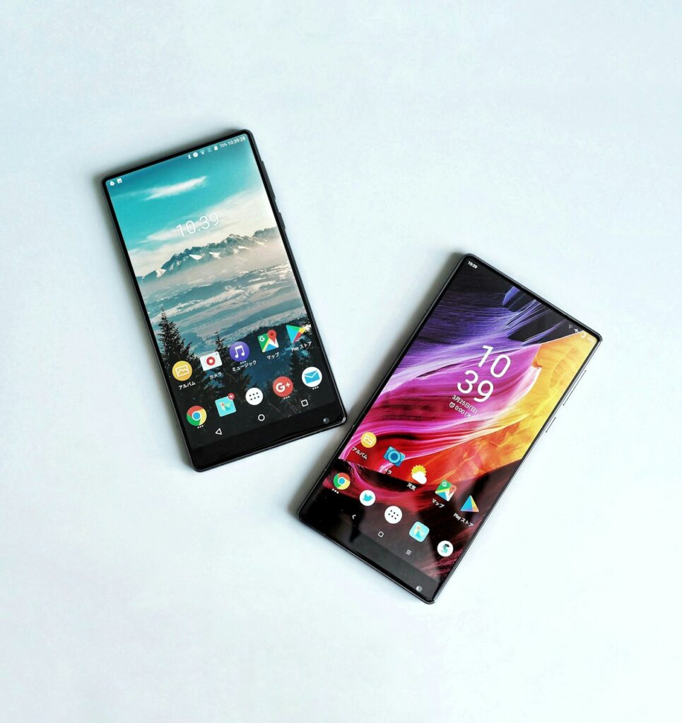 Two smartphones side by side comparing iSave and YNAB budget apps
