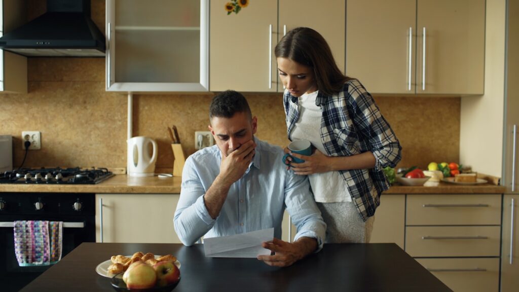 Person stressed by overspending and unpaid bills